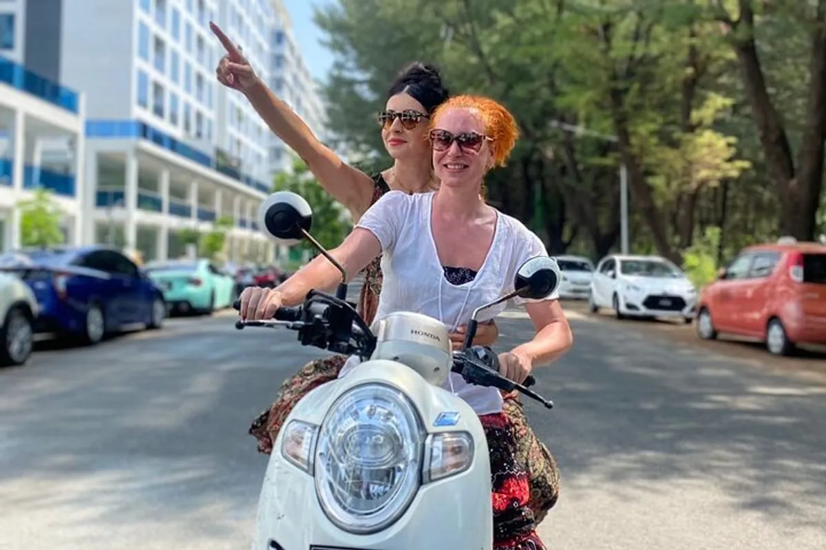 Tourists riding a scooter in Hulhumale Maldives using Atovo rental